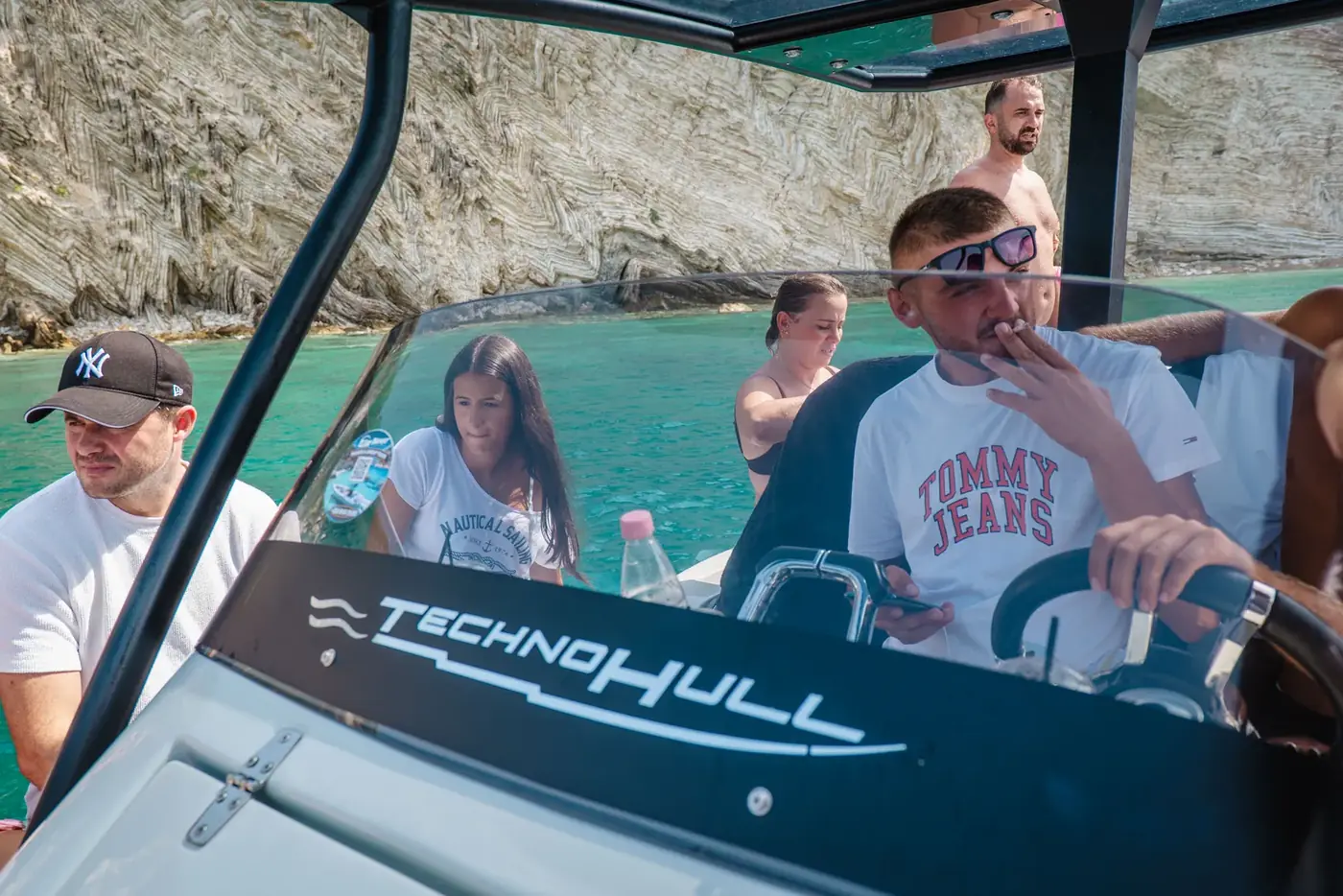 The Beast Boat's helm console branded Technohull, with guests seated along the tube behind it