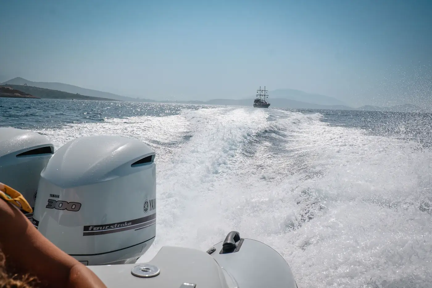 Twin Yamaha outboards on the Beast Boat throwing a wide white wake across the Albanian Riviera